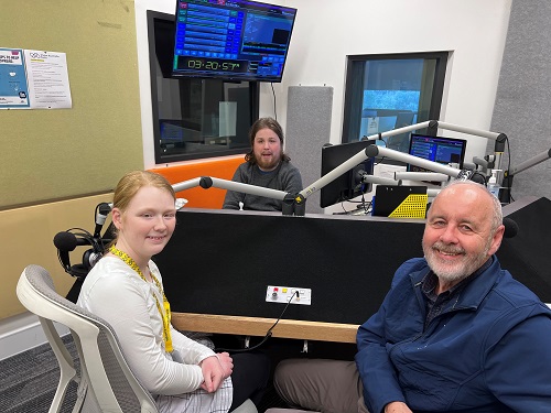 "THree people sit in a radio studion"