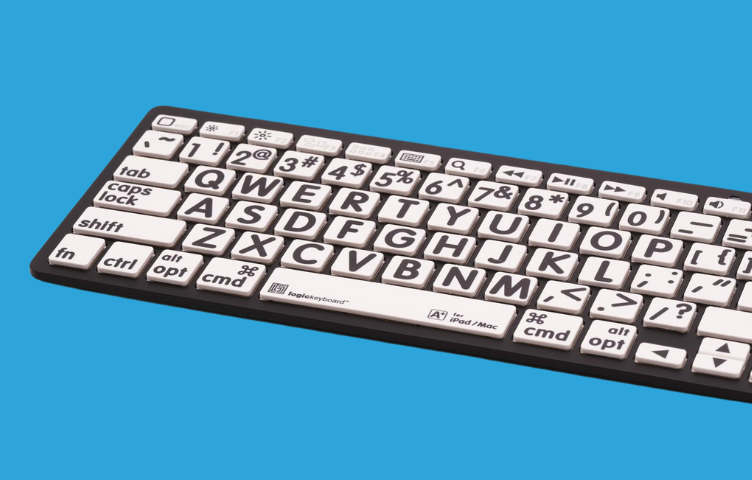 A high-contrast keyboard with white keys and black font sits against a bright blue background.