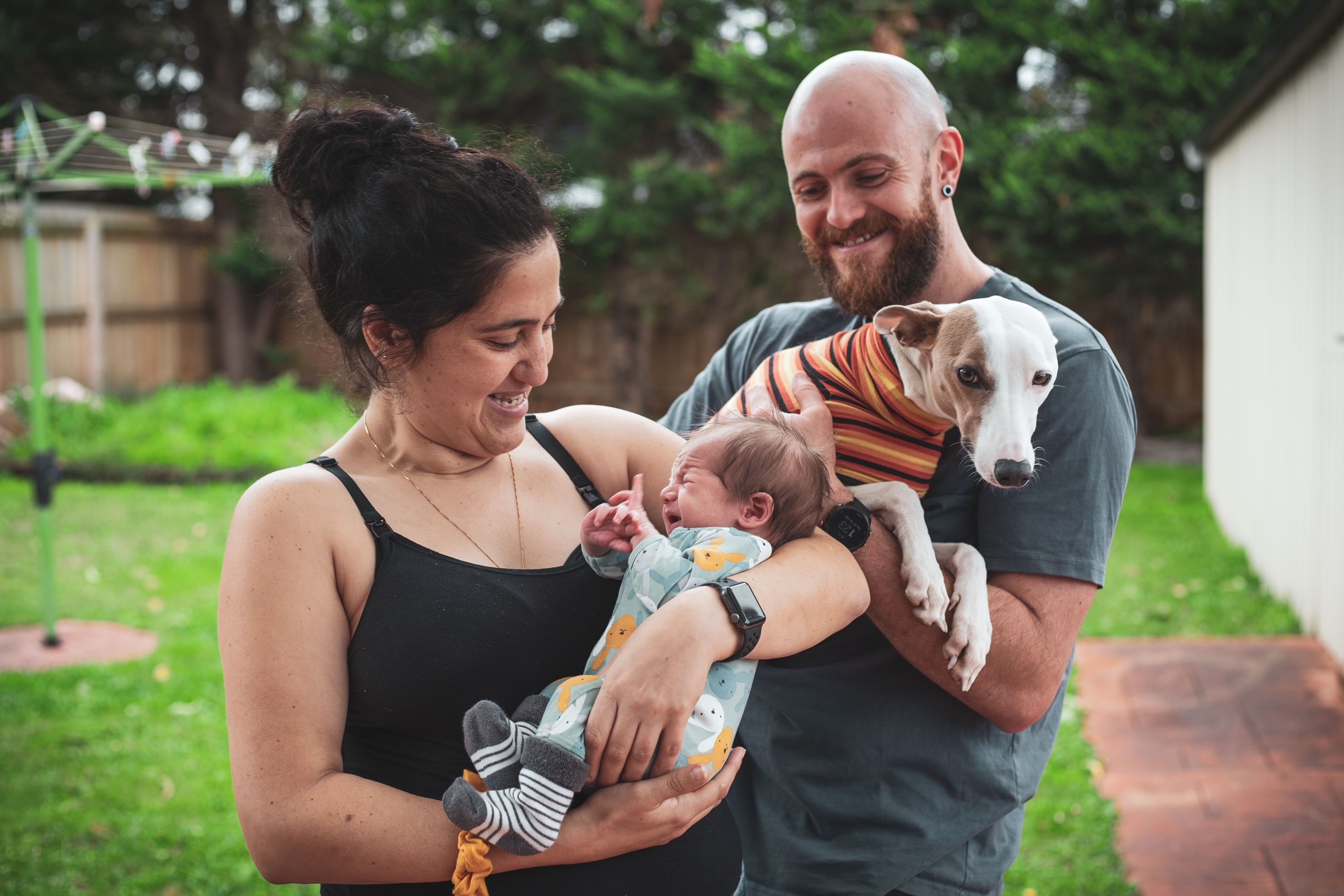 Lauren, Chris and Eddy together as a family, Chris is holding the family dog.