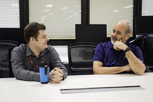 Two men sit at a table