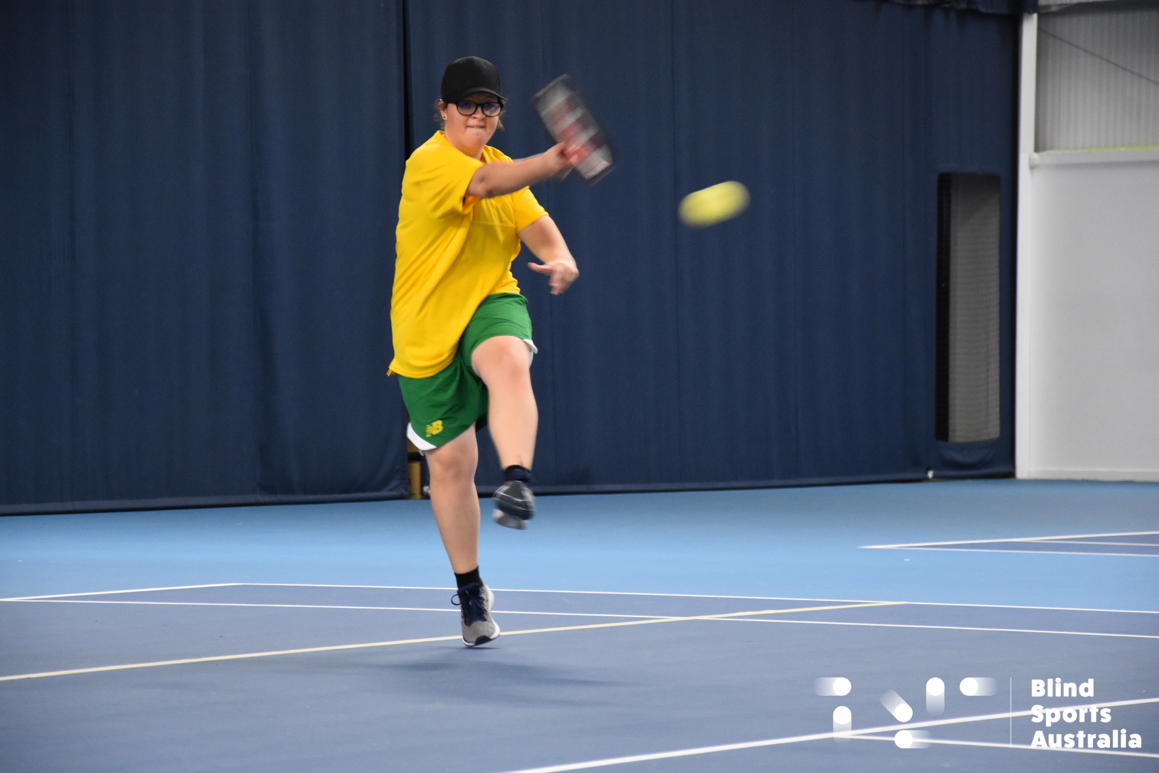 Action shot of Grace Hobbs hitting a Blind Tennis ball.