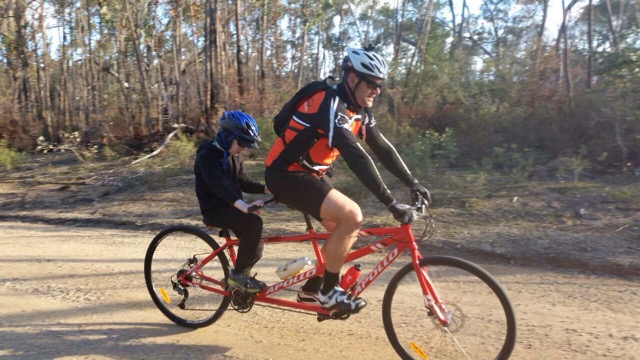 Max and Thom on the tandem bike riding through the bush