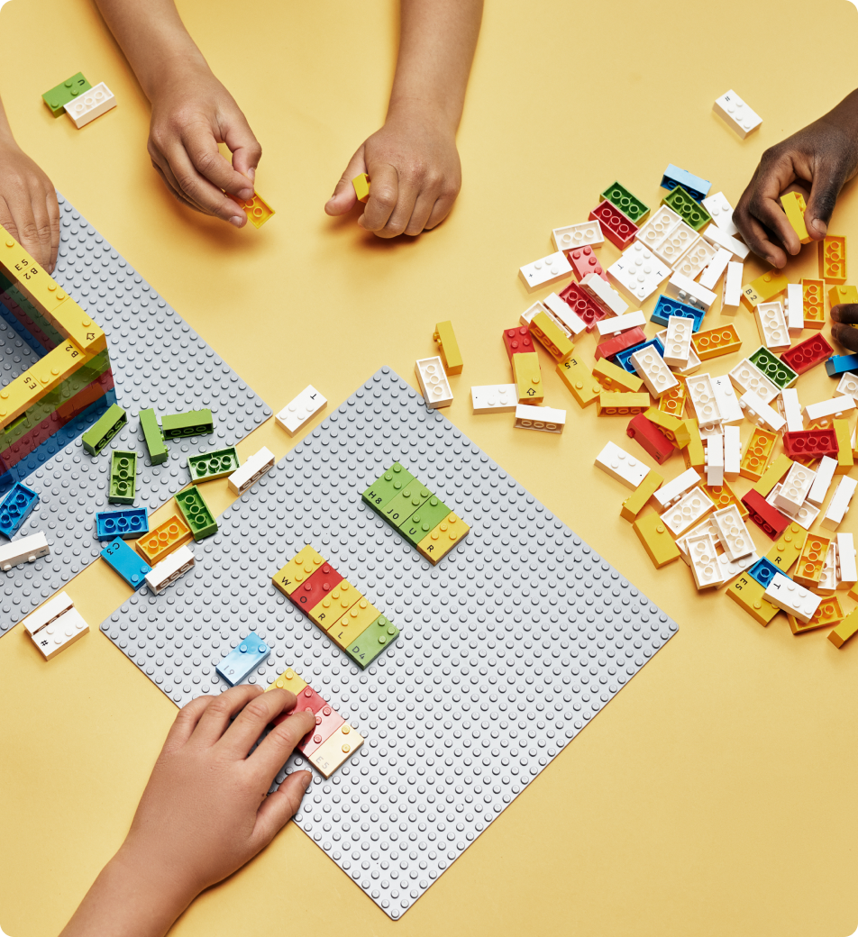 Kid's hands playing with Lego bricks