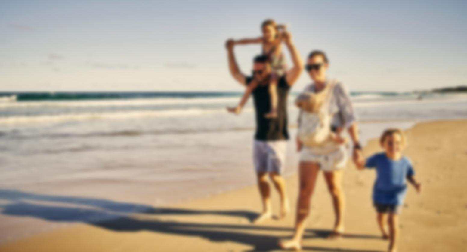 Cataracts: Image of a happy family walking on the beach that is completely blurred. Cataracts: Image of a happy family walking on the beach that is completely blurred.