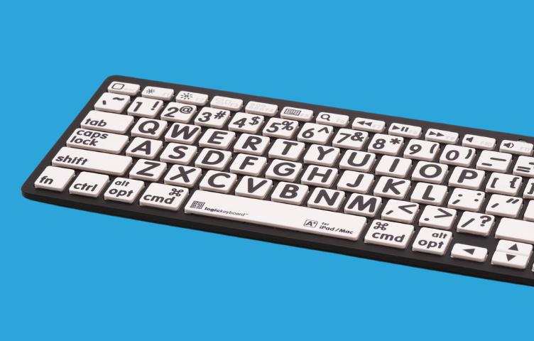 A high-contrast keyboard with white keys and black font sits against a bright blue background.