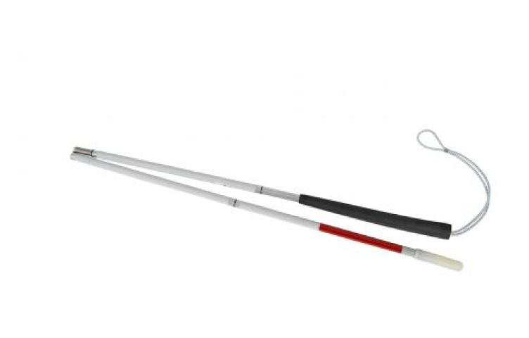 A white folding cane with a black grip, red tip, and wrist strap.